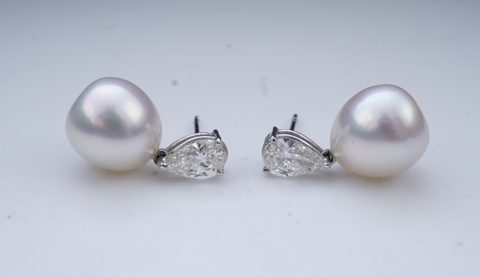 A pair of cultured pearl and diamond earrings
